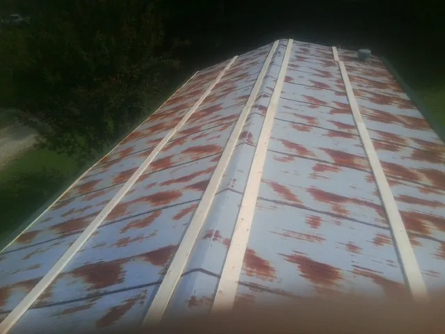 Rusted metal roof panels with new wood purlins before replacement — Storm Damage Roof Repair in Tres Pinos by Roofing Brothers